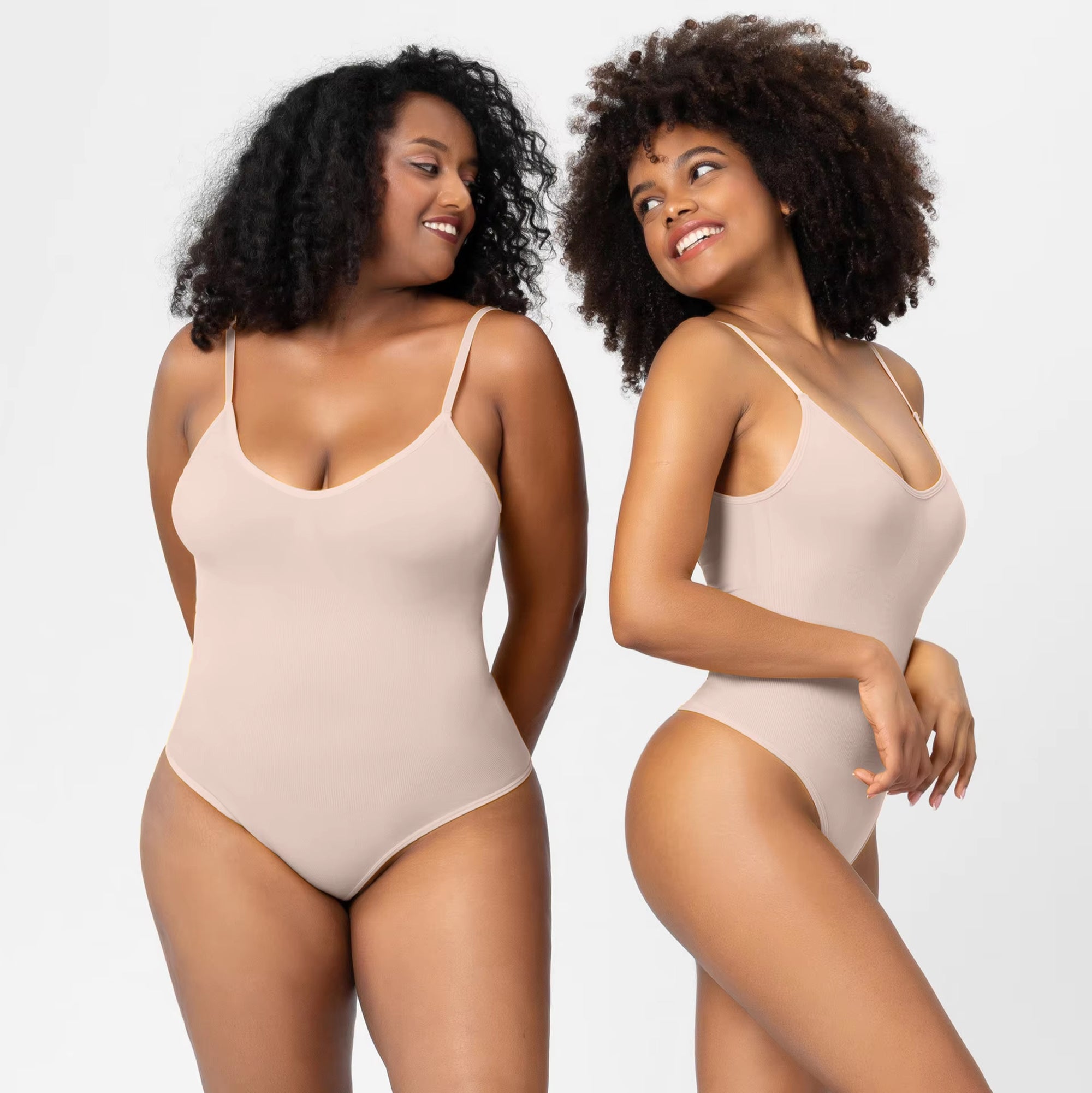 Two women wearing beige bodysuits on a plain background